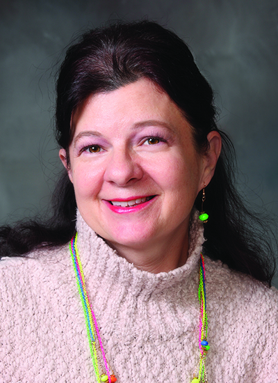 Dr. Yvonne Saunders-Teigeler wearing pink sweater in headshot