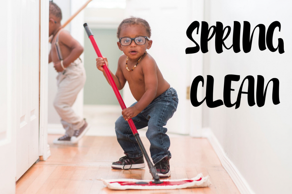 young back toddler wearing jeans and glasses mopping the floor