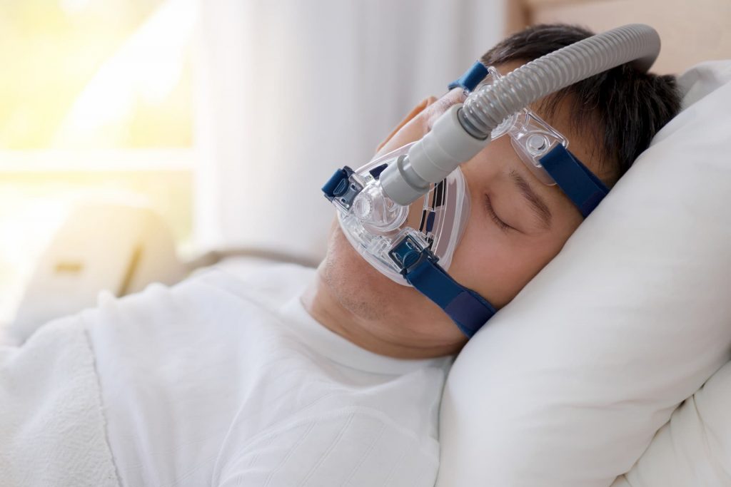 Man wearing CPAP machine for sleep apnea