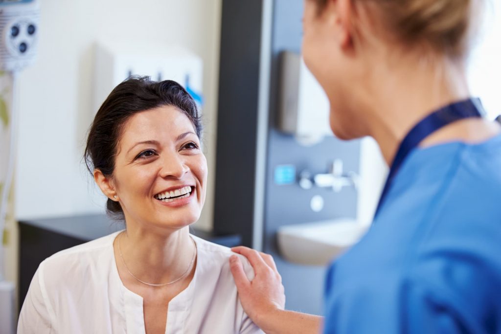 Hispanic patient smiling at nurse
