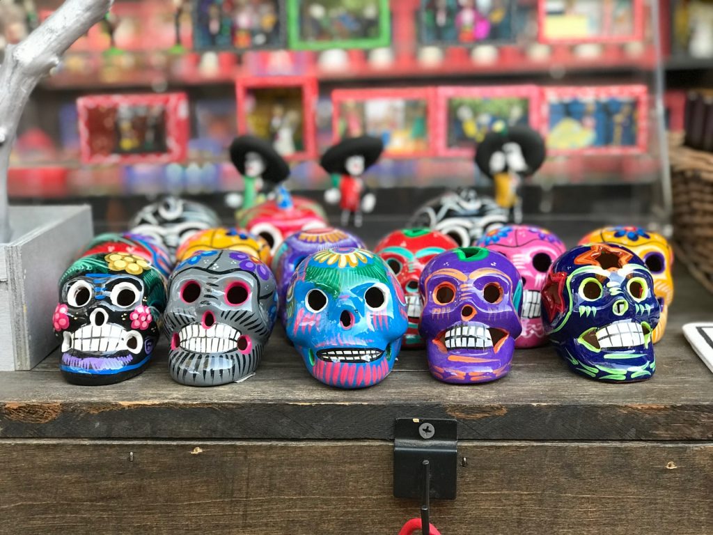 A bunch of painted sugar skulls for Dia de los Muertos - a safer way to celebrate during the COVID-19 pandemic